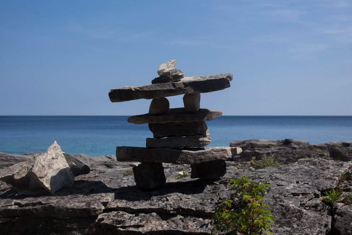 A small inukshuk is seen on a rock beach in Ontario's Bruce Peninsula National Park on August 4, 2016. 