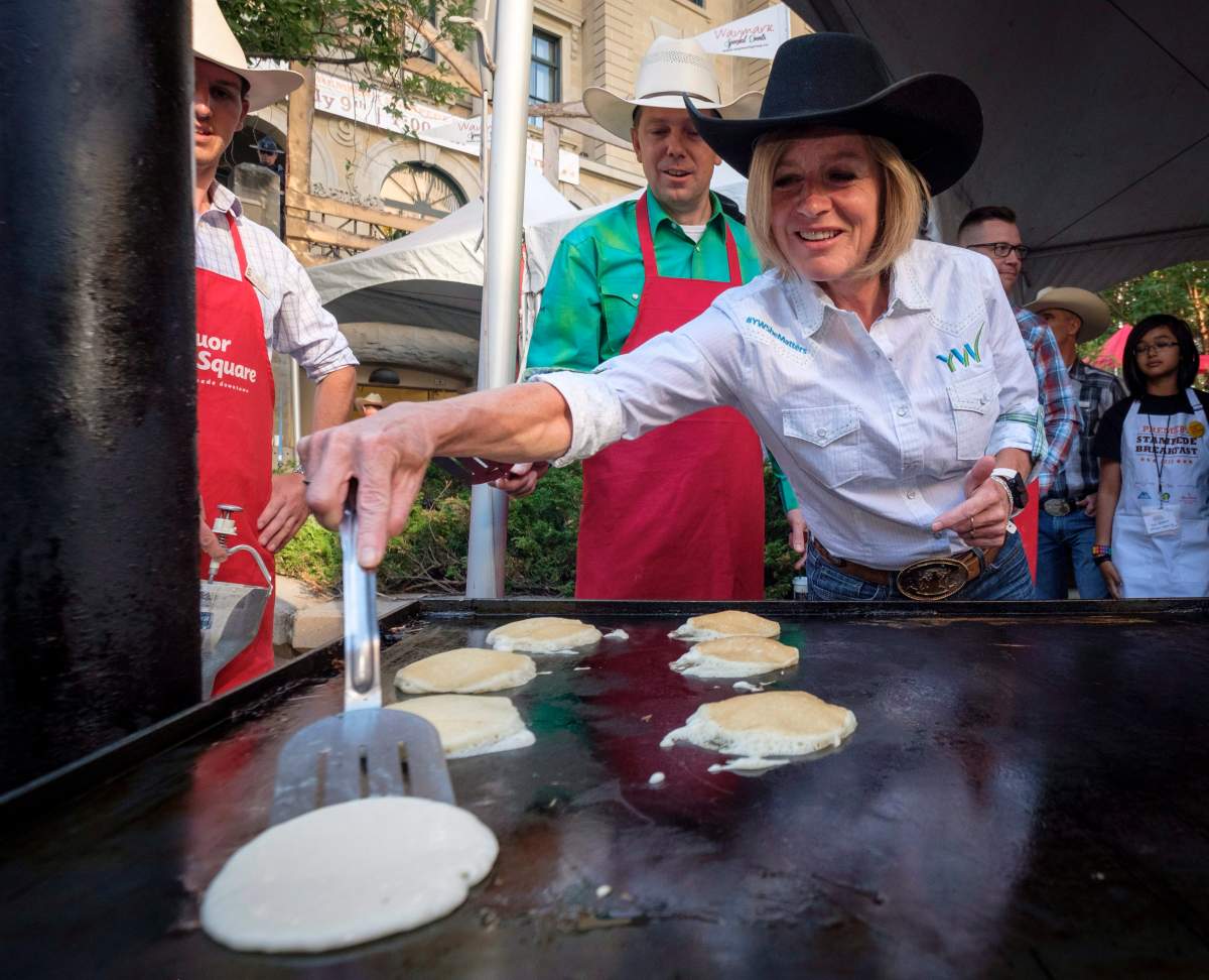 Alberta Premier Rachel Notley cooks pancakes as she attends her annual Stampede breakfast in Calgary on Monday, July 9, 2018.