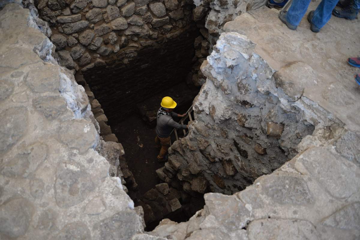 Archaeologists work at the archaeological site of Teopanzolco, Morelos state, Mexico, 11 July 2018.