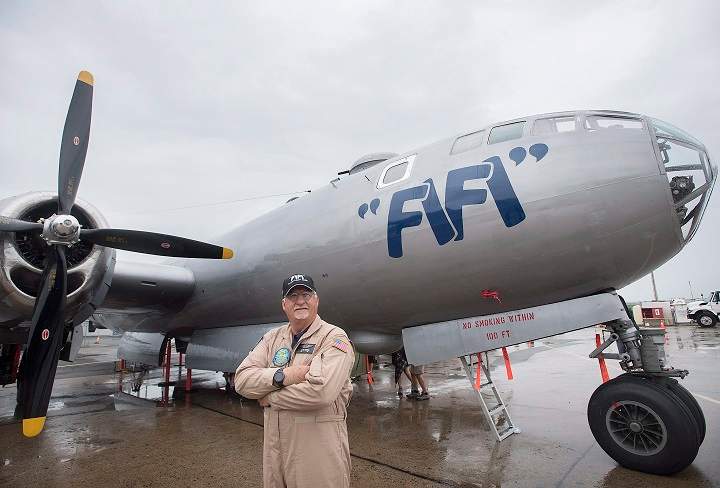 Pilot Allen Benzing poses next to FIFI, a Boeing B-29 Superfortress at Saint-Hubert airport south of Montreal, Sunday, July 22, 2018.THE CANADIAN PRESS/Graham Hughes