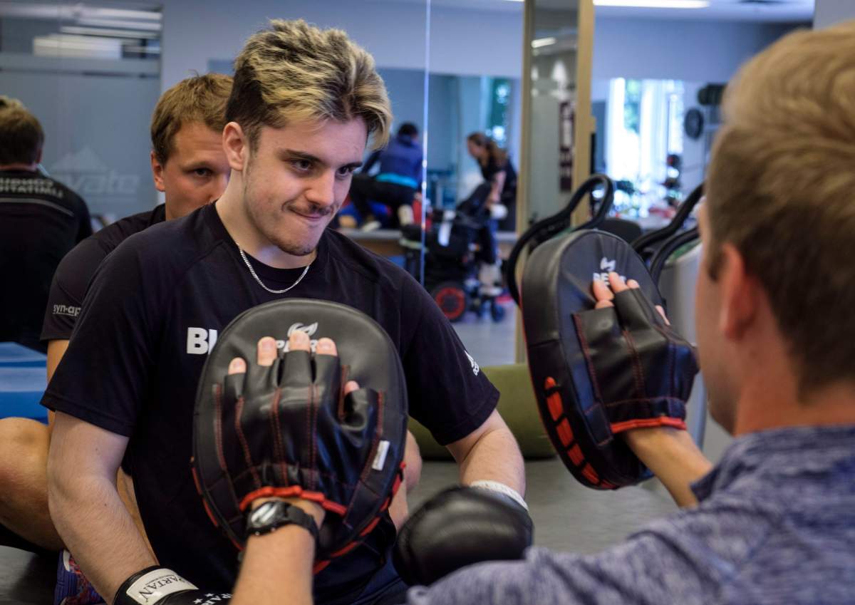 Humboldt Broncos bus crash survivor Ryan Straschnitzki, attends physio session with Kinesiologist Kirill Dubrovskiy, left, and physiotherapist Nelson Morela, right, in Calgary, Alta., Monday, July 16, 2018.