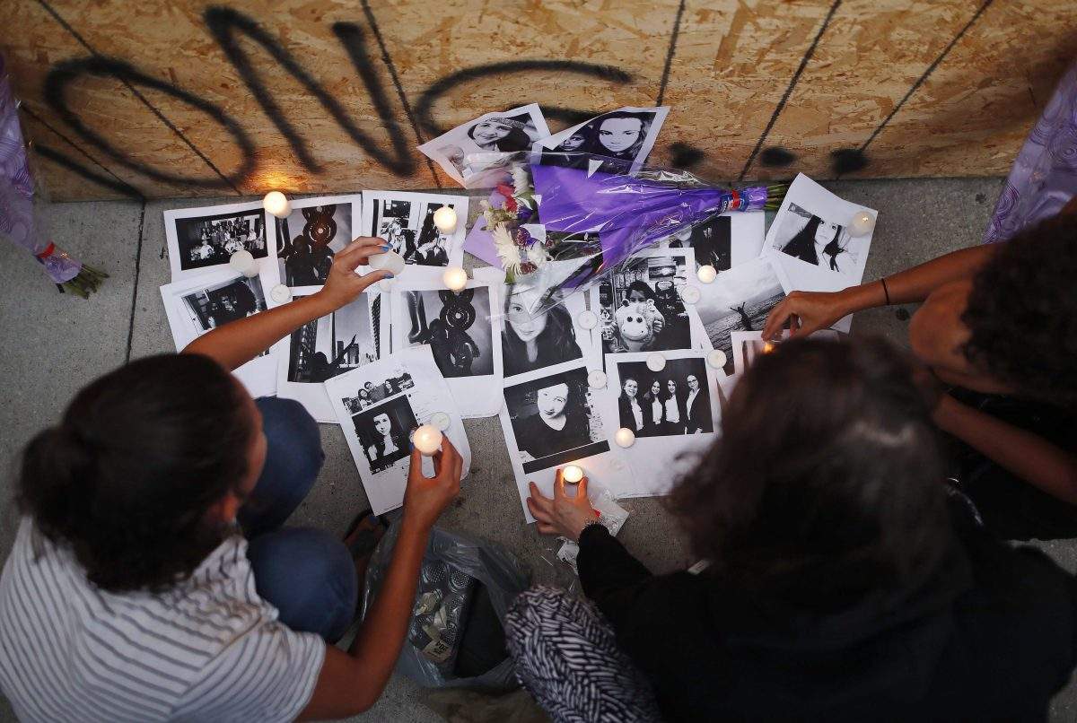People light candles and leave photos of 18-year-old victim Reese Fallon at a memorial remembering the victims of a shooting on Sunday evening on Danforth, Ave. in Toronto on Monday, July 23, 2018. THE CANADIAN PRESS/Mark Blinch