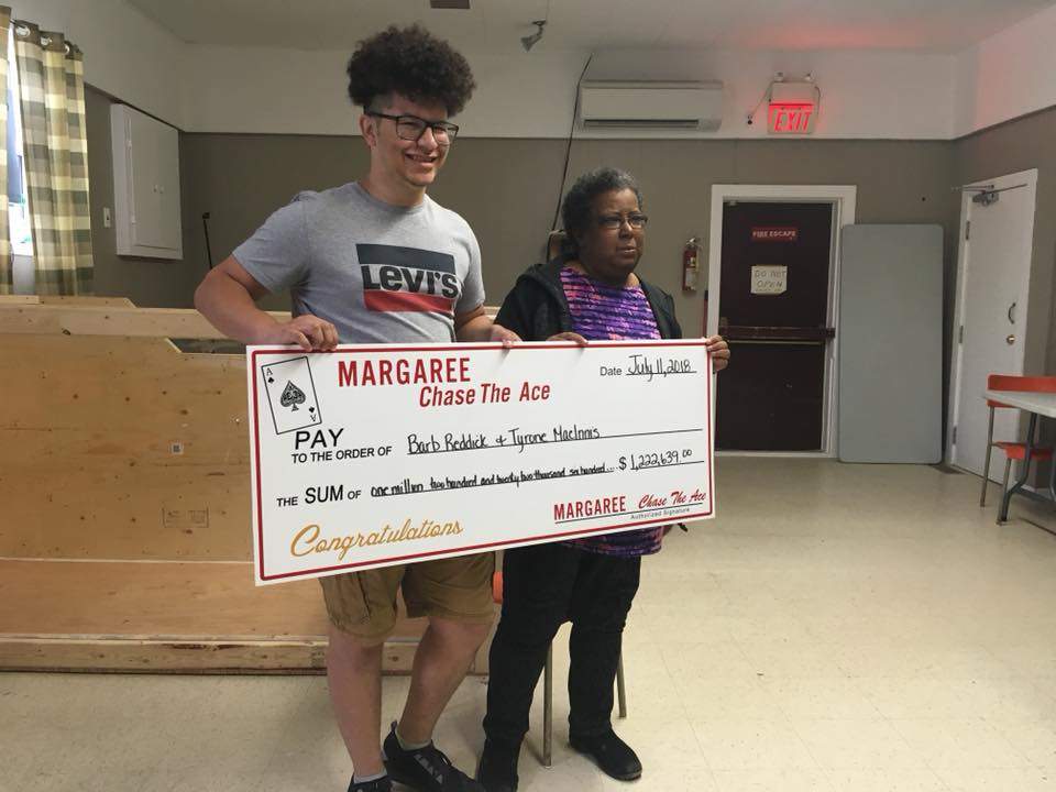 Barb Reddick and her nephew Tyrone MacInnis are seen accepting their prize in July.