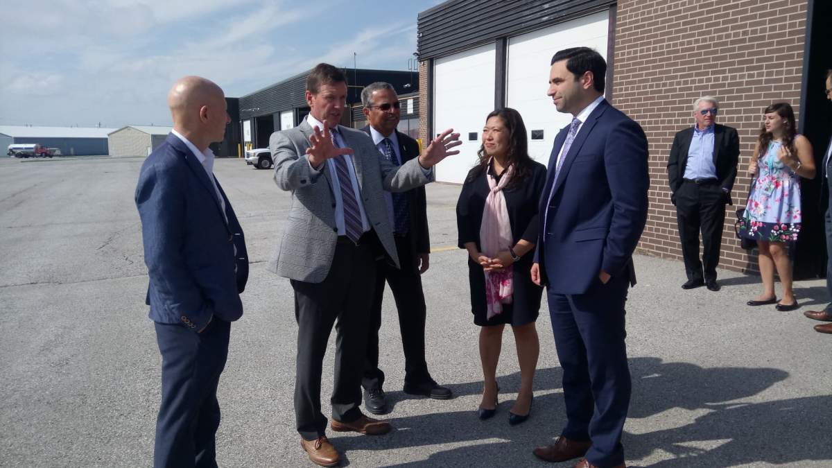 London airport president Mike Seabrook shows politicians the runway that will be improved as a result of the federal funding.