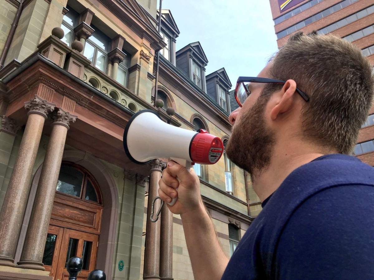 A group of protestors opposed to the municipality’s changes regarding smoking and cannabis use on public property protest outside of Halifax City Hall on July 31, 2018.