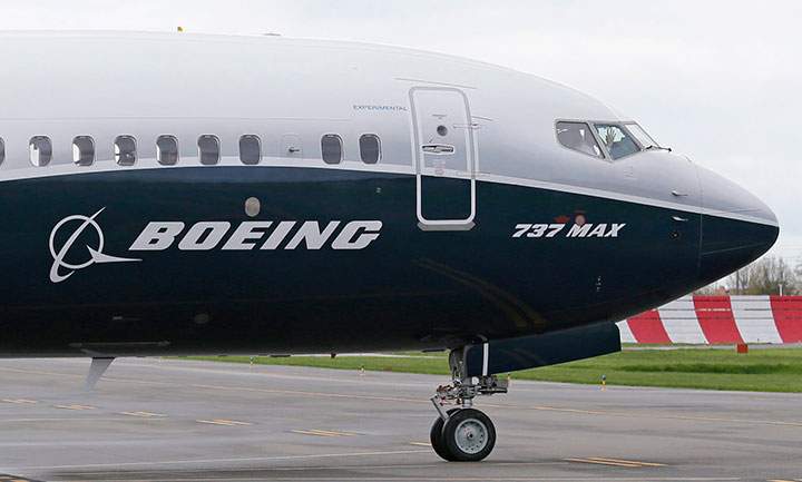 In this April 13, 2017 file photo, a pilot waves from the flight deck of a Boeing 737 MAX 9 as it rolls out for the airplane's first flight, in Renton, Wash. 