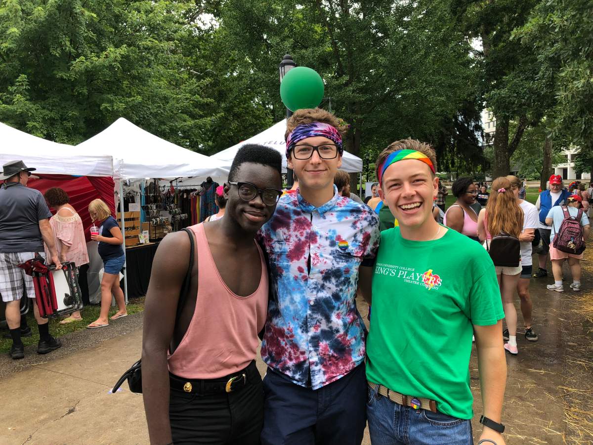 Caleb (left) is joined by his friends Brent and David during the 24th annual London Pride Parade.