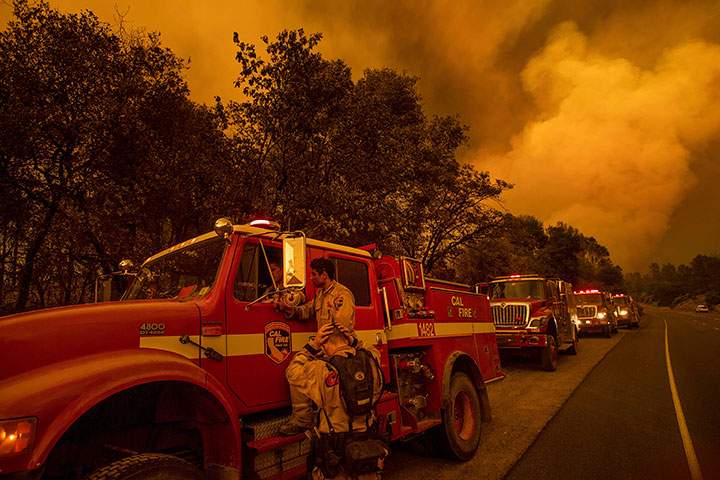 Firefighters regroup while battling the Carr Fire in Shasta, Calif., on Thursday, July 26, 2018.