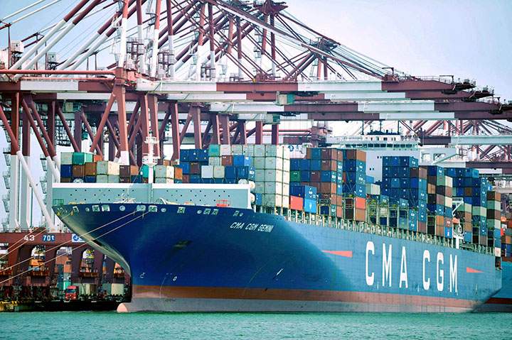 In this July 6, 2018, photo, a container ship is docked at a port in Qingdao in eastern China's Shandong Province. 