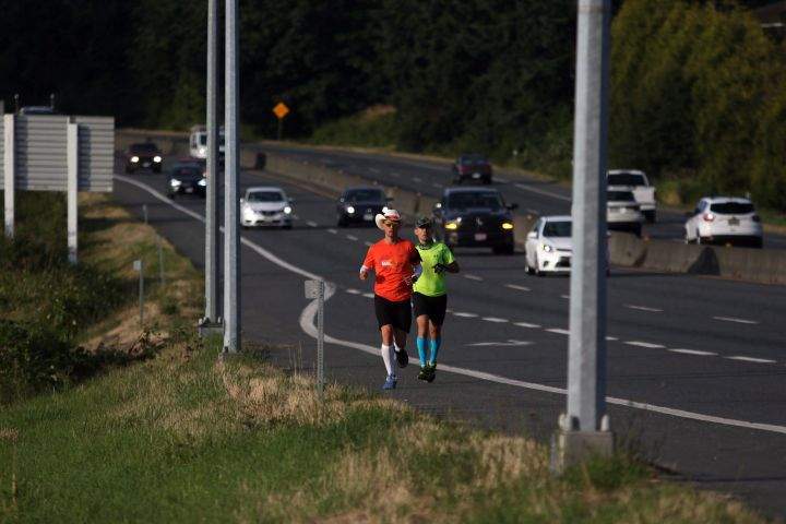 Dave Proctor runs with a friend along Hwy. 17 towards his goal of running across Canada in support of rare disease and medical study as he makes his way along Blanshard St. from Mile Zero in Victoria, B.C., on Wednesday June 27, 2018. Proctor's goal is to run 7200 kilometres in 66 days with a goal of raising 1 million dollars for research. 