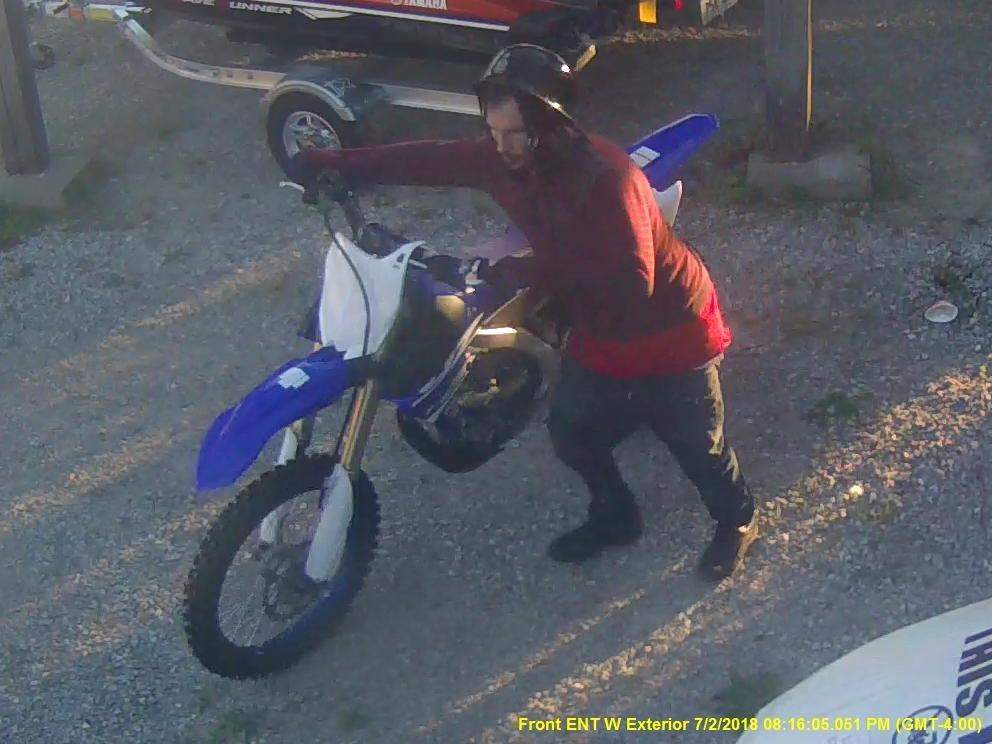 Police are looking to identify a man (above) accused of stealing a dirt bike from a dealership in Innisfil.