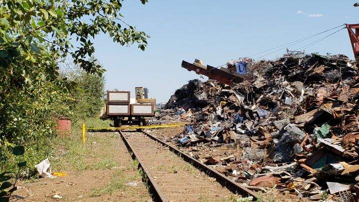 Police tape is seen by a scrap metal cart near 45 Street and 68 Avenue in Edmonton on July, 6, 2018. Police said two men suffered life-threatening injuries at the scene in an incident that involved a train.