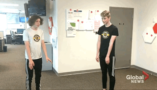 Winnipeg gymnasts Pierce Barlow and Isaiah Klassen do a flip in the Global newsroom Tuesday.