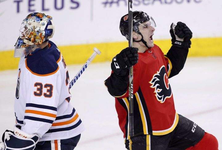 Edmonton Oilers goalie Cam Talbot (33) skates away as Calgary Flames' Garnet Hathaway celebrates his short-handed goal during first period NHL action in Calgary on Saturday, March 31, 2018. The Flames have re-signed American winger Hathaway to a one-year contract.
