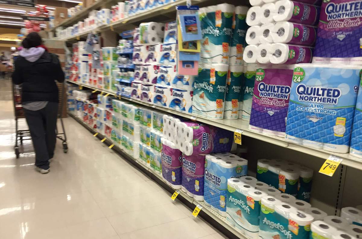 A shopper pushes a cart down the toilet paper aisle at Safeway in Bowie, Maryland, on January 20, 2016, as weather forecasts predict an incoming blizzard to the area.