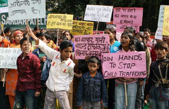 In this Dec. 12, 2008 file photo, Indian children shout slogans during a demonstration on the Global Day against Child Trafficking in New Delhi.


