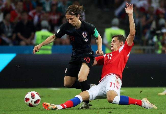 Croatia’s Luka Modric evades a tackle from Russia’s Roman Zobnin during a 2018 FIFA World Cup quarterfinal match at Fisht Olympic Stadium in Sochi, Russia.
