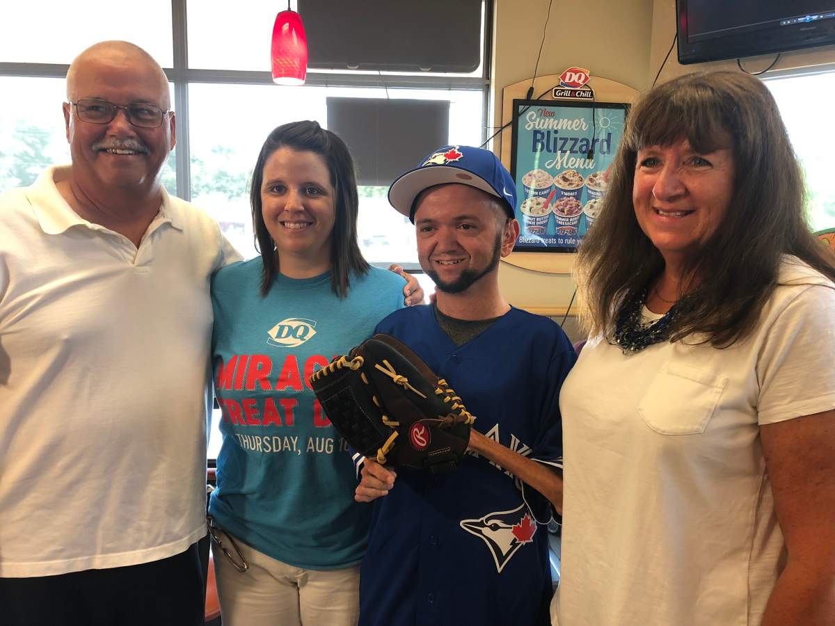 Raymond Hardisty, surrounded by family and friends, was surprised with the opportunity to throw the first pitch at a Toronto Blue Jays game.