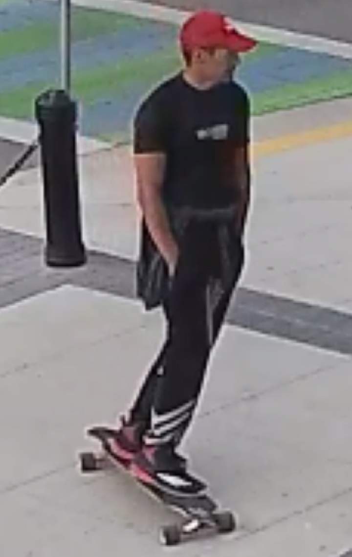 This surveillance photo shows the alleged suspect wearing a red hat, a black t-shirt and black pants.