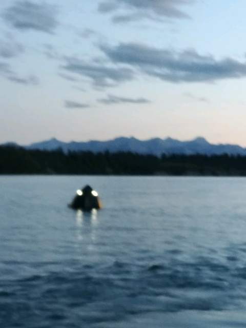 A blurry photo of a boat sinking on Ghost Lake, west of Calgary. Ten people had to be rescued because of it. July 14, 2018.