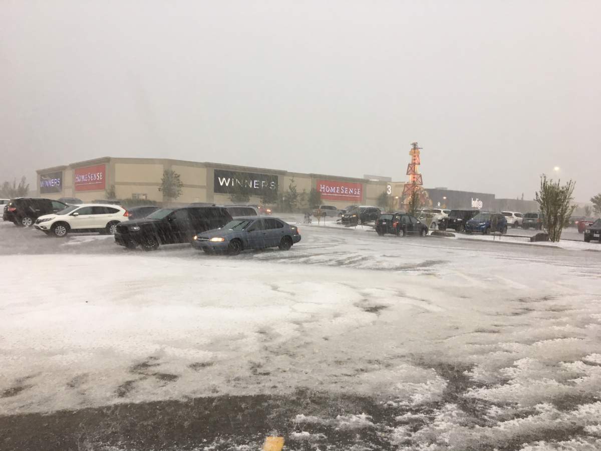 Hail blankets a parking lot at Cross Iron Mills shopping centre on July 23.