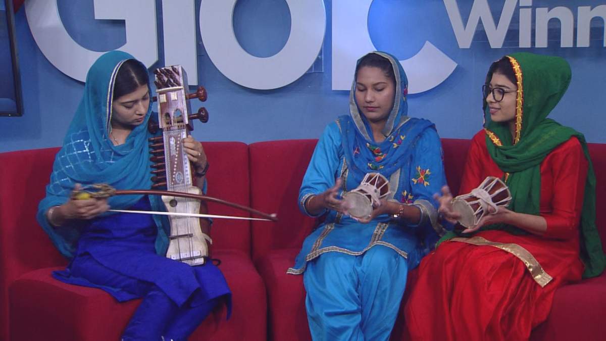 The sarangi is being played on the left while two dhads are being played on the right.