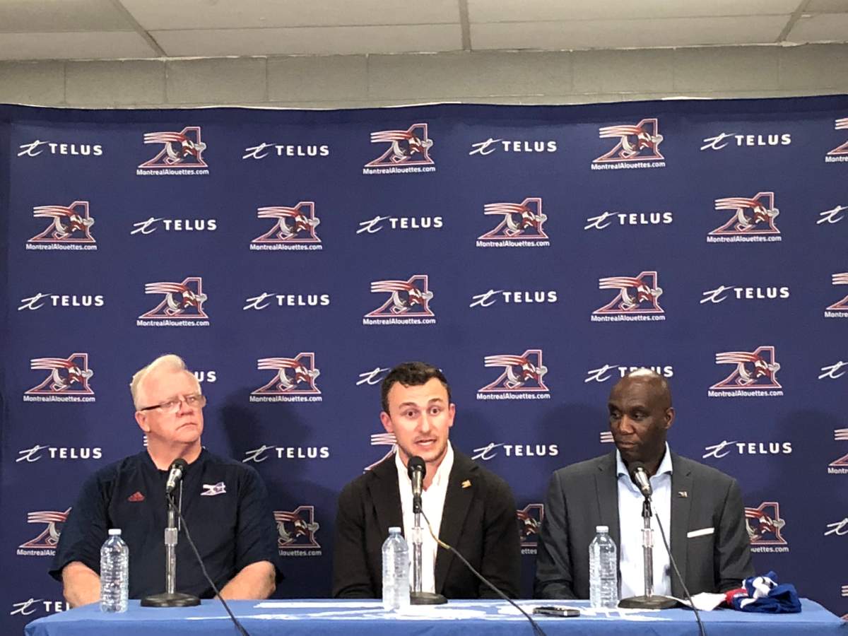 Johnny Manziel flanked by the Montreal Alouettes coach Mike Sherman to the left and the team’s general manager Kavis Reid to the right. Monday July 23, 2018.