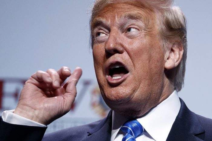 U.S. President Donald Trump gestures to music as he arrives to speak at the Veterans of Foreign Wars of the United States national convention Tuesday, July 24, 2018, in Kansas City, Mo. 