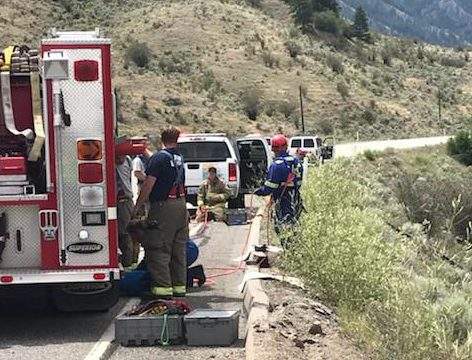 Emergency vehicles assemble following a single vehicle crash on Highway 3 in the South Okanagan Monday, July 9, 2018. 