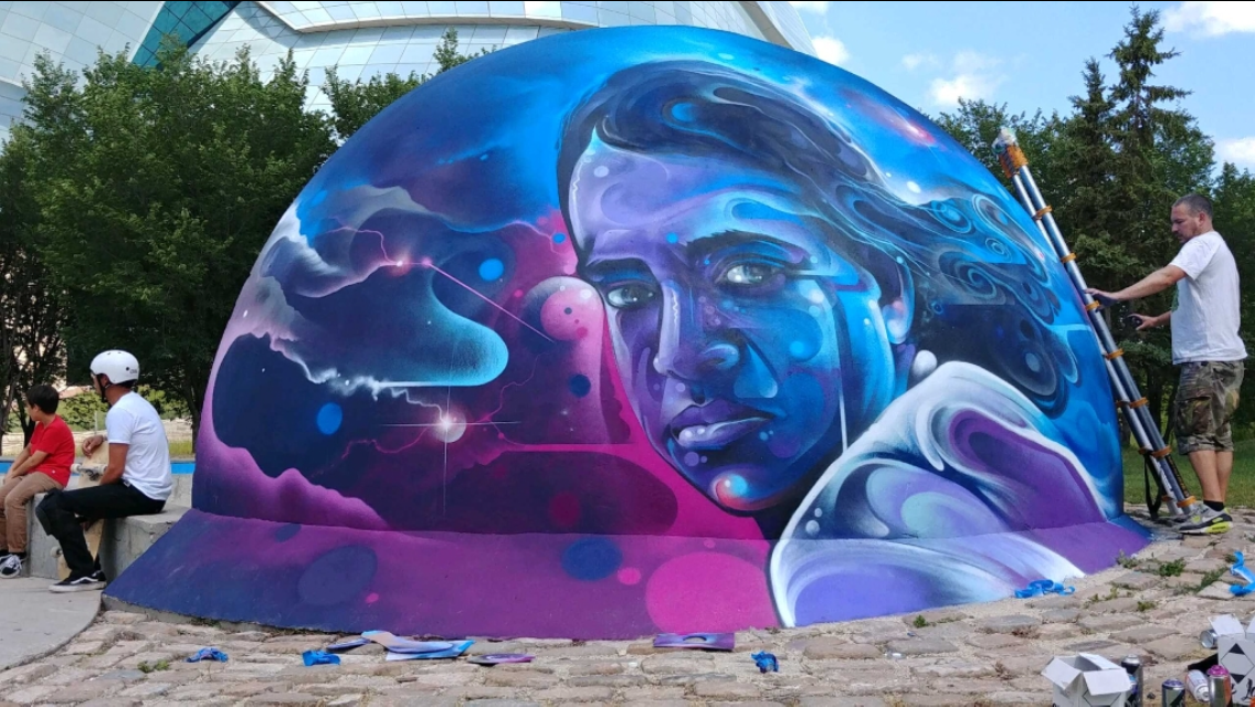 Artist Mr. Cenz working on a mural to honour the late founder of Sk8 Skates at The Plaza Skateboard Park.