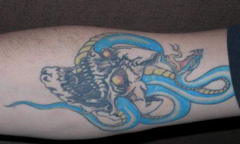Police say Russell has several tattoos, including a skull with a snake coming out of it on his right forearm