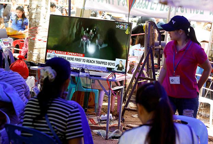 Family members watch a television news broadcast of the trapped members of an under-16 soccer team and their coach, after they have been found alive, in the northern province of Chiang Rai, Thailand, July 4, 2018.