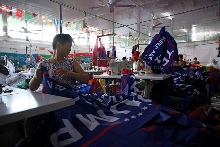 Workers make flags for U.S. President Donald Trump’s “Keep America Great!” 2020 re-election campaign at Jiahao flag factory in Fuyang, Anhui province, China July 24, 2018.