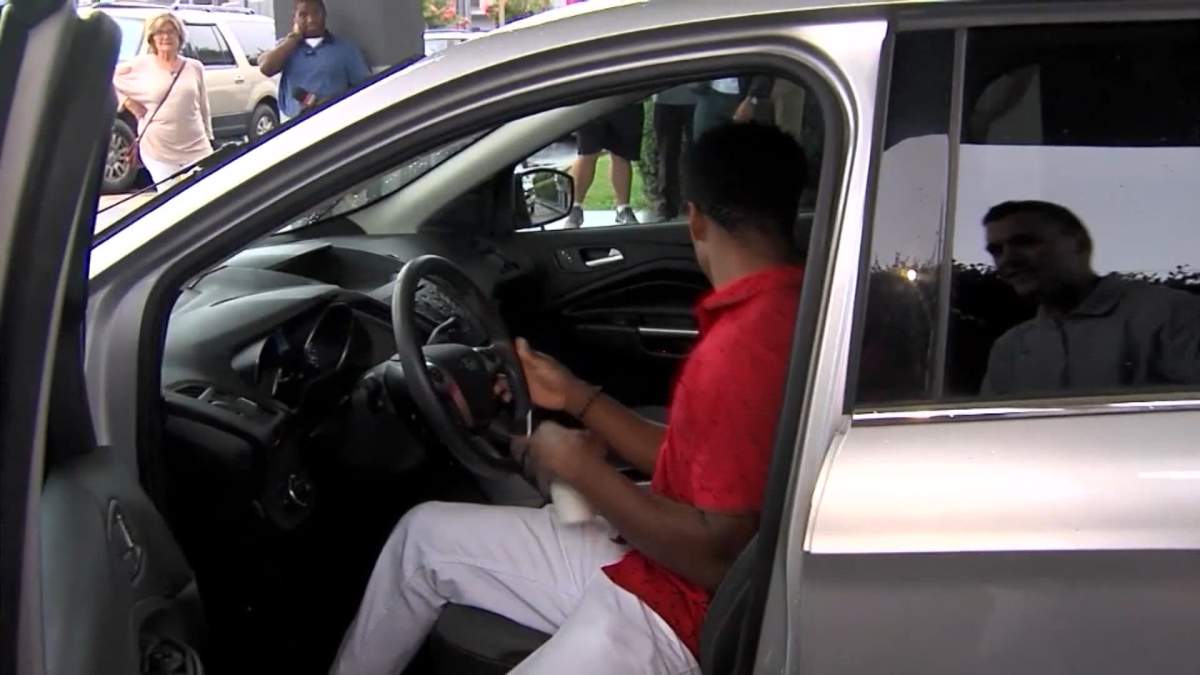 Walter Carr gets into his new car on Monday, July 16, 2018, after it was presented to him by the company CEO.