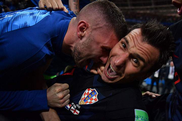 Croatia’s forward Mario Mandzukic celebrates with teammates after scoring his team’s second goal during the Russia 2018 World Cup semi-final between Croatia and England at the Luzhniki Stadium in Moscow on July 11, 2018.