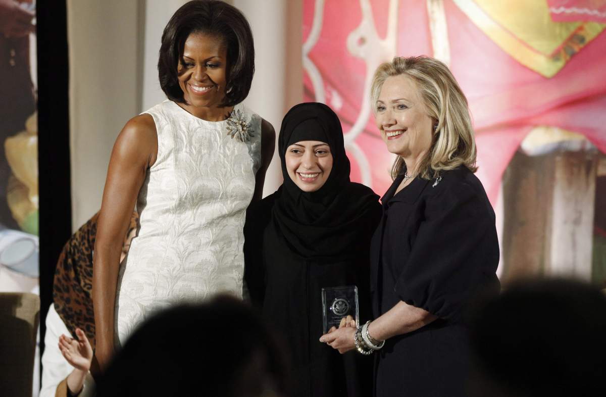 Secretary of State Hillary Rodham Clinton and first lady Michelle Obama present the 2012 International Women of Courage Award to Samar Badawi of Saudi Arabia. 