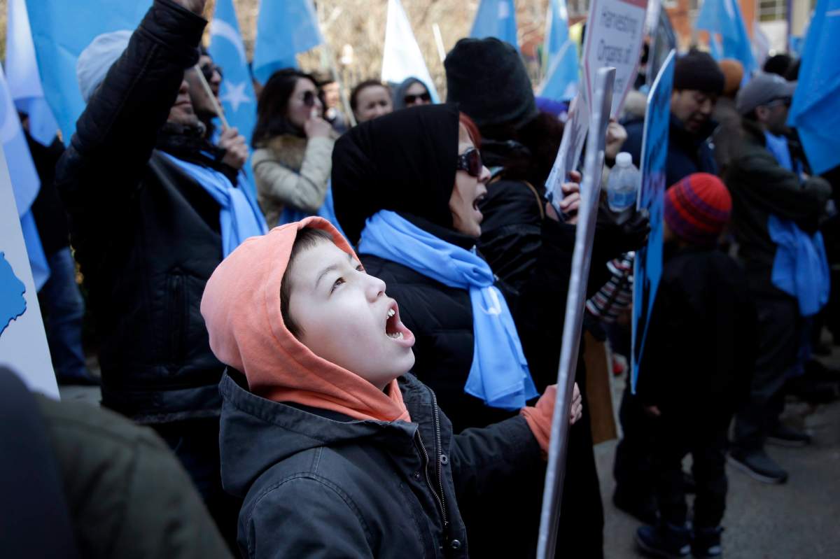 Uighurs and their supporters protest in front of the Permanent Mission of China to the United Nations in New York, Thursday, March 15, 2018.