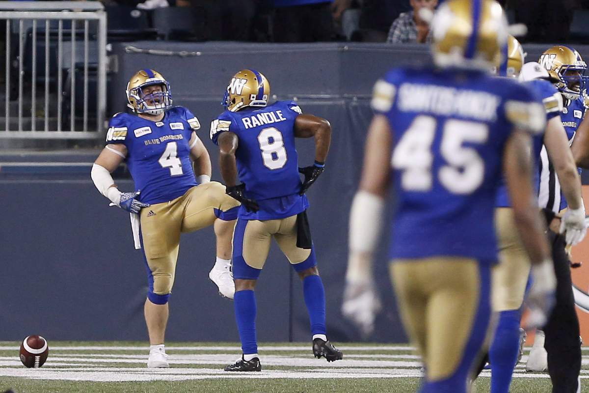 Winnipeg Blue Bombers’ Adam Bighill (4) and Chris Randle (8) celebrate Bighill’s interception and touchdown during second half CFL action against the BC Lions, in Winnipeg on Saturday, July 7, 2018.