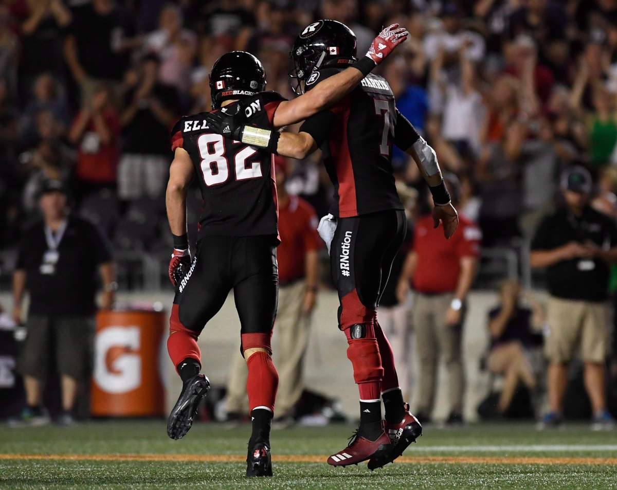 Ottawa Redblacks quarterback Trevor Harris (7) celebrates a touchdown with teammate Greg Ellingson (82) during second half CFL action against the B.C. Lions, in Ottawa on Friday, July 20, 2018.