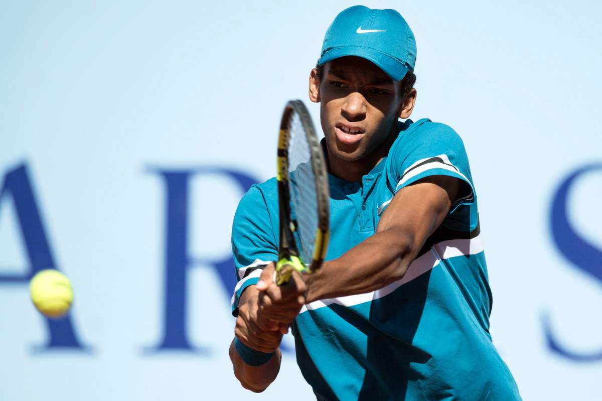 Felix Auger-Aliassime of Canada returns a ball to Viktor Galovic of Croatia during a second round game at the Swiss Open tennis tournament in Gstaad, Switzerland, 26 July 2018.  