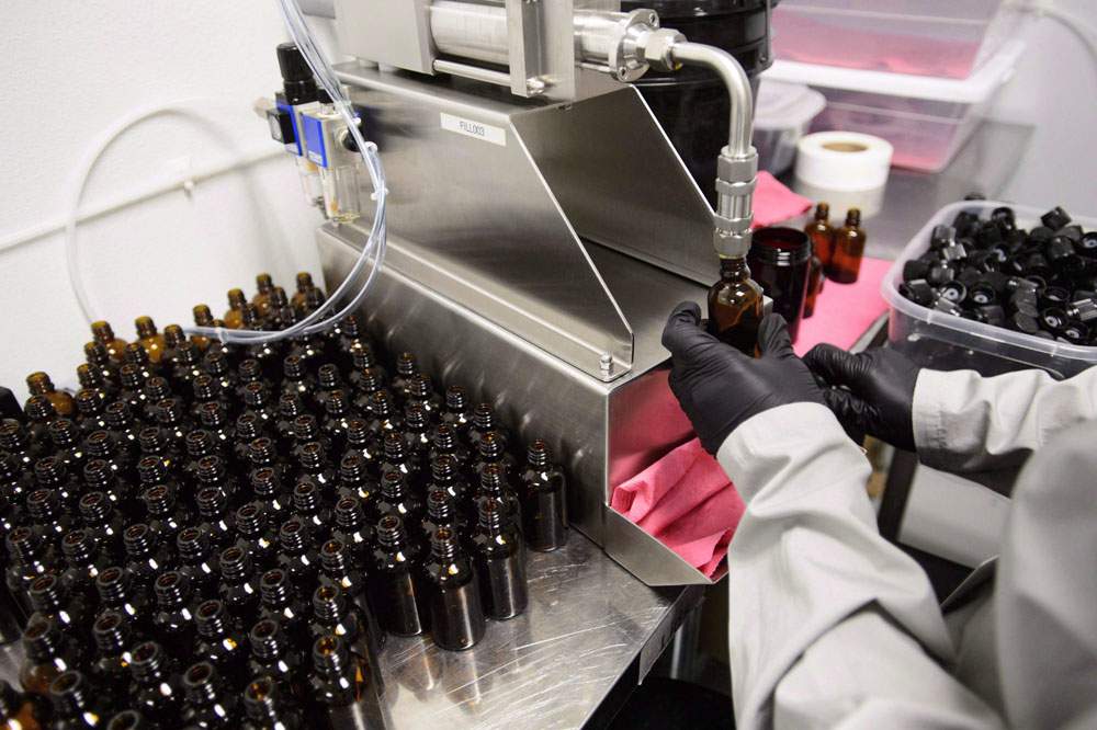 Workers package cannabis oil at Canopy Growth Corporation's Tweed facility in Smiths Falls, Ont., in this file image. 