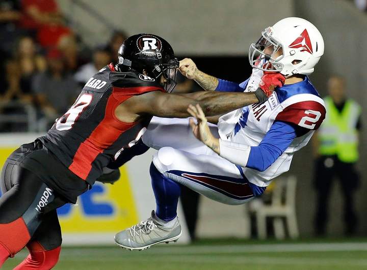Ottawa Redblacks A.C. Leonard (99) tackles Montreal Alouettes quarterback Johnny Manziel (2) during fourth quarter CFL action in Ottawa on Saturday, August 11, 2018.  