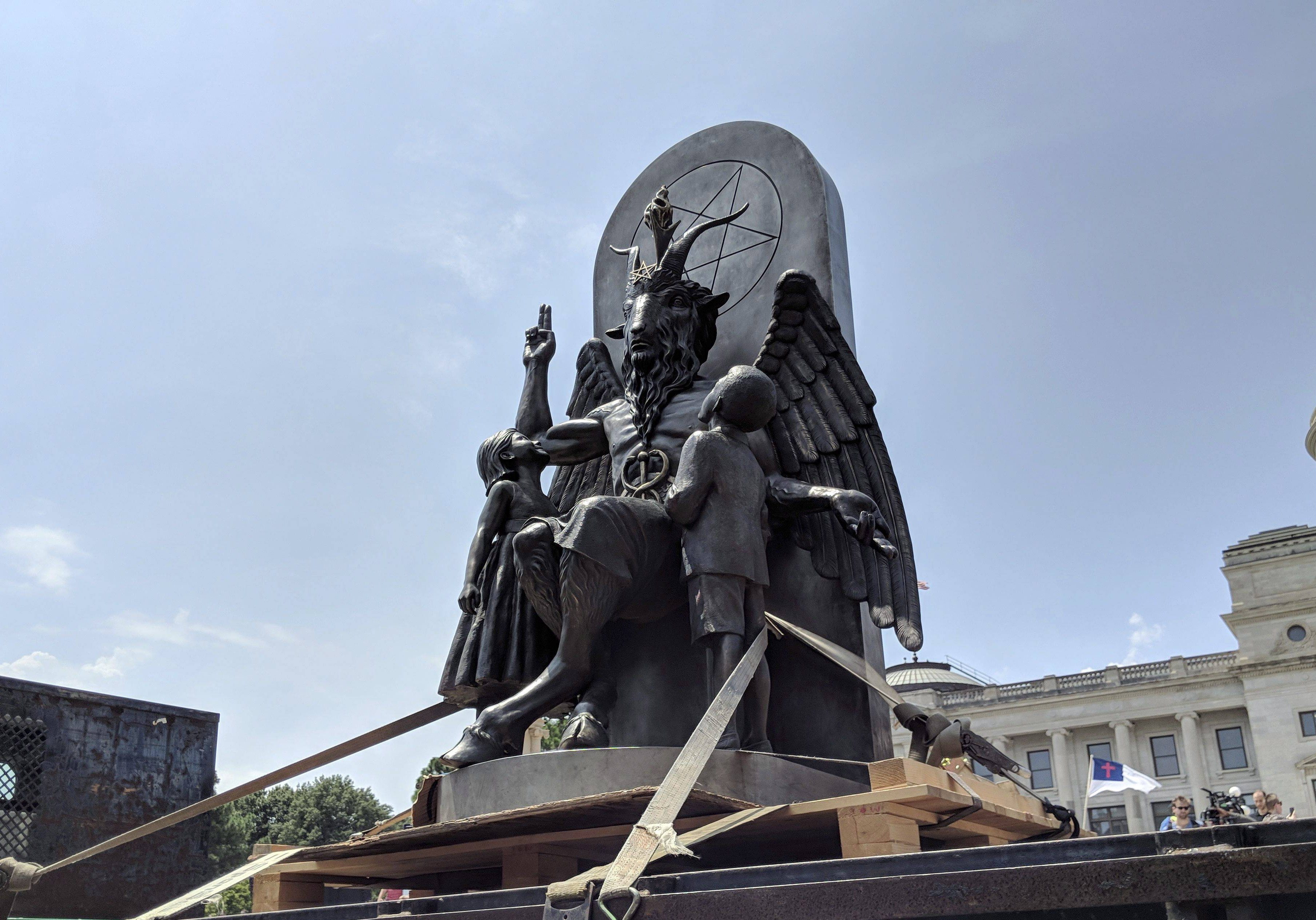 The Satanic Temple unveils its statue of Baphomet, a winged goat creature, at a rally for the First Amendment in Little Rock, Ark., Thursday, Aug. 16, 2018.