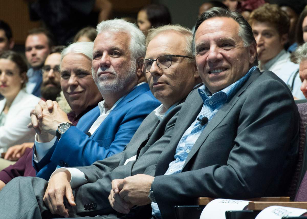 Québec Solidaire spokesperson Manon Massé, left to right, Quebec Premier Philippe Couillard, Parti Québécois leader Jean-François Lisée and CAQ leader François Legault participate in a youth-oriented event in Montreal, Friday, August 17 2018.