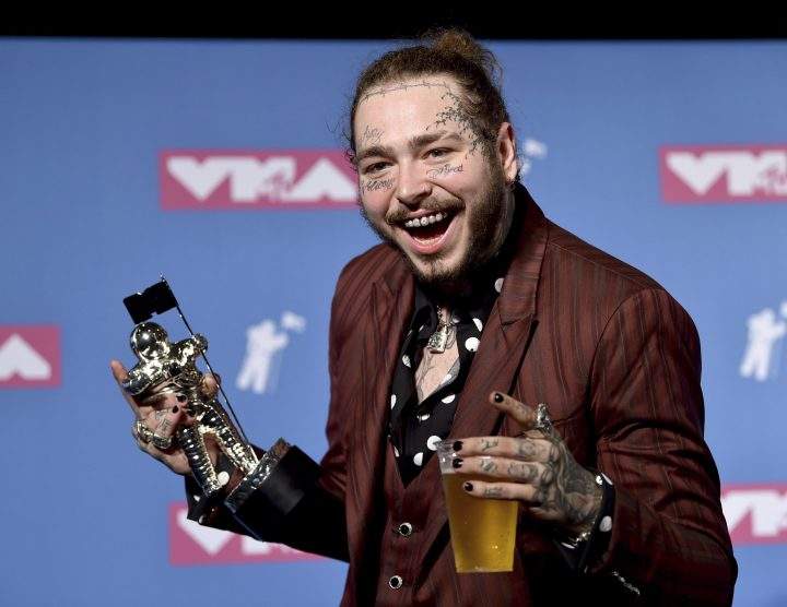 Post Malone poses with the award for song of the year for “Rockstar” in the press room at the MTV Video Music Awards at Radio City Music Hall on Monday, Aug. 20, 2018, in New York.