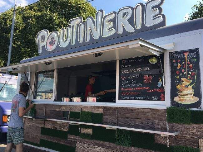 Owners Masha Klimova and Alexey Kolesov's "Poutinerie" food truck is being prepared for the day at the Faces & Laces Festival in Gorky Park, Moscow, Russia, Aug. 18, 2018. 