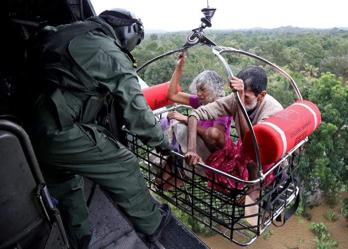 People are airlifted by the Indian Navy soldiers during a rescue operation at a flooded area in the southern state of Kerala, India, August 17, 2018.
