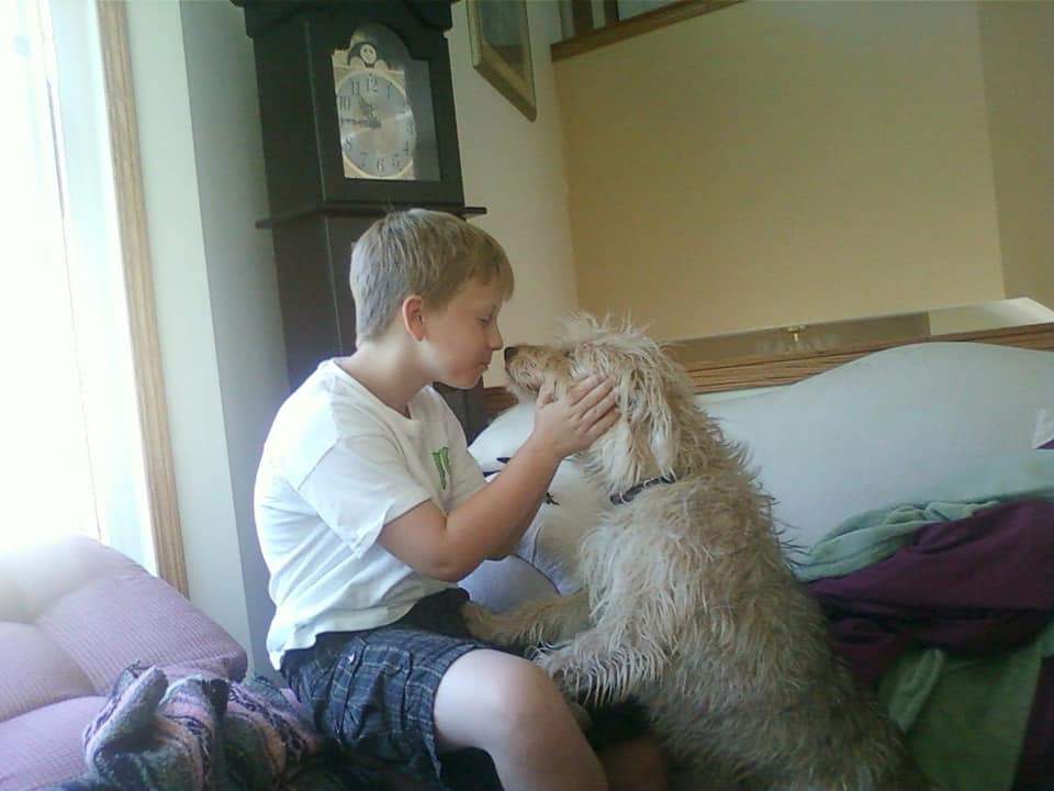 Ben Harris snuggles up to his dog, Pretzel.