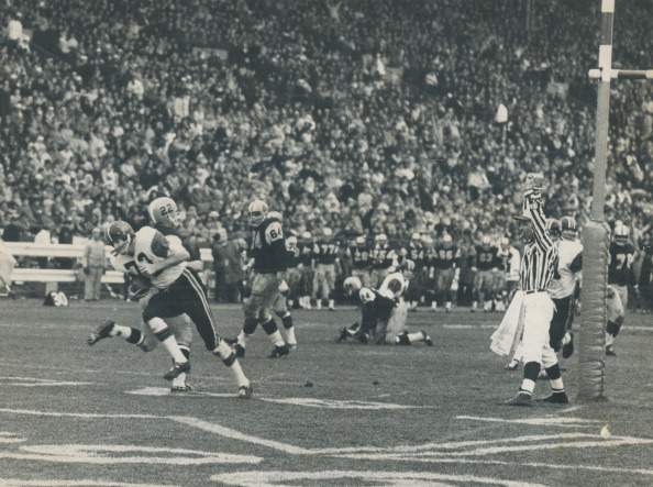 CANADA - NOVEMBER 28:  Busted play brings touchdown. Just as the second quarter began in today's Grey Cup game between B.C. field-goal attempt. Pete Ohler quickly straightened up with the skidding ball as Jim Karphin broke into the end zone. Ohler's pass beat Ti-Cats' Don Sutherin (22) and Lions led 13-0; later stretched out to 20-1.