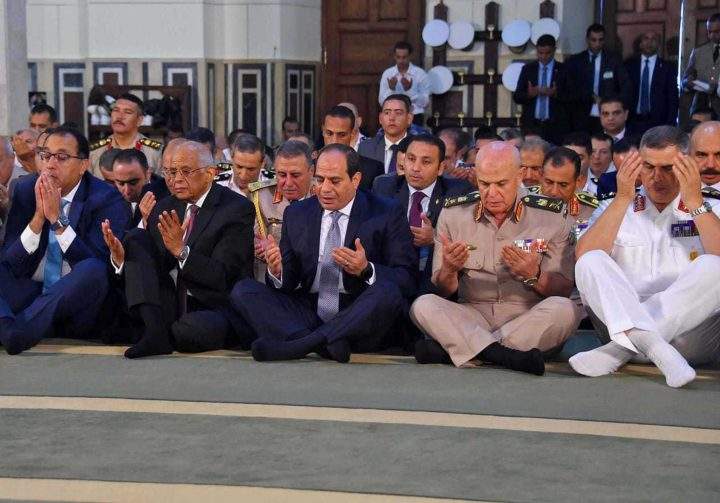 Egyptian President Abdel-Fattah el-Sissi, centre, and officials attend the Eid al Adha prayer, in Cairo, Egypt, Sunday, Aug. 21, 2018.